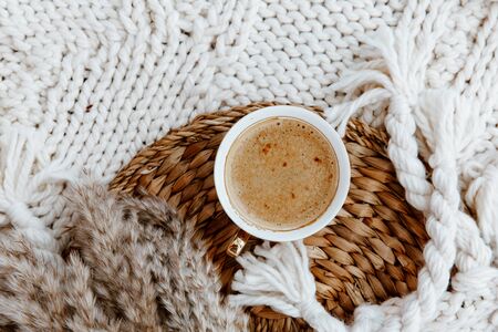 Flat lay cup of coffee, plaid blanket on rattan straw. Morning breakfast. Minimal modern interior design concept. Still Life conceptの写真素材