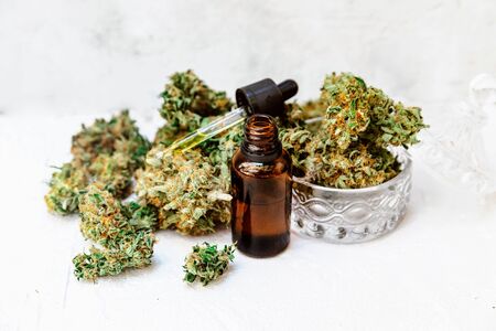 Cannabidiol oil in bottles with droppers on white surface, Medical Cannabis ( Marijuana ) oil ready for consumption の写真素材