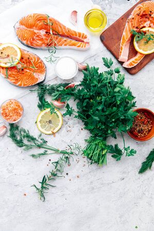 Delicious portion of fresh salmon fillet with aromatic herbs, spices - healthy food, diet or cooking conceptの写真素材