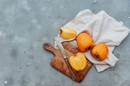Ripe sweet persimmons, top view, flat layの写真素材