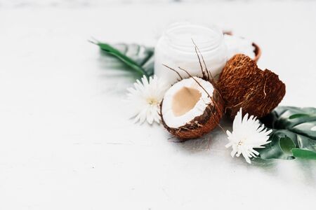 Composition with coconut products, coco oil in jar and tropical leaves. Care productsの写真素材