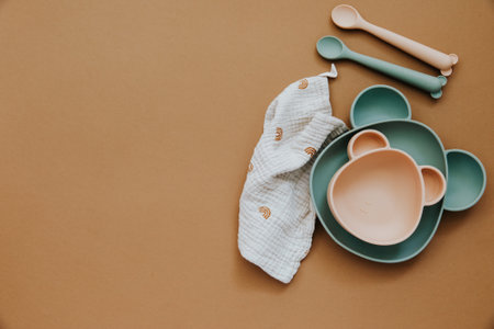 Flat lay composition with baby food accessory, plastic fruits, on light background. First baby food...
