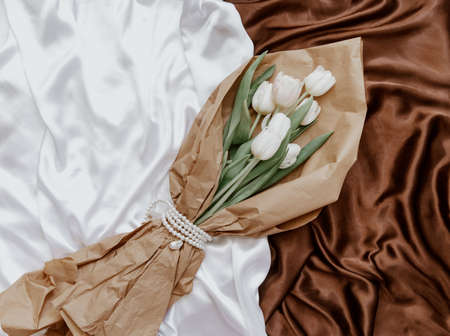 White tulips on silky background. Elegant bouquet flower, top viewの写真素材