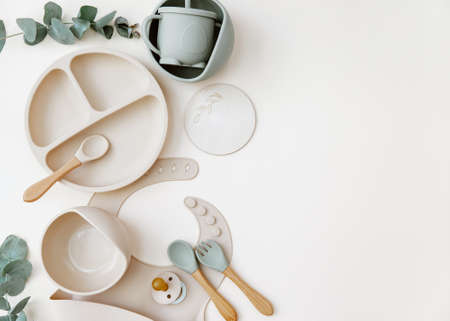 Baby Table Setting Background. Silicone set on light background. Place for text, copy space. Top view, flat lay.の写真素材