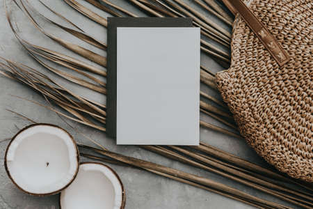 Creative summer minimal mock-up. Dried palm leaves and coconut on neutral background. Still life...