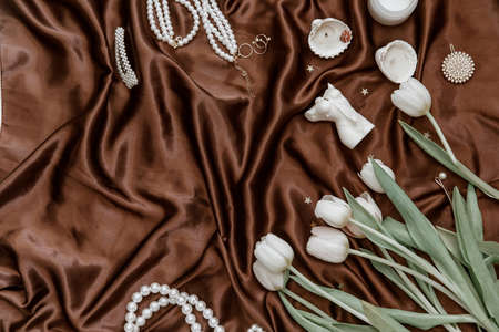 Flat lay fashion collage with women accessories. Bouquet of spring white tulips .The concept of Valentine's day and women's day.の写真素材