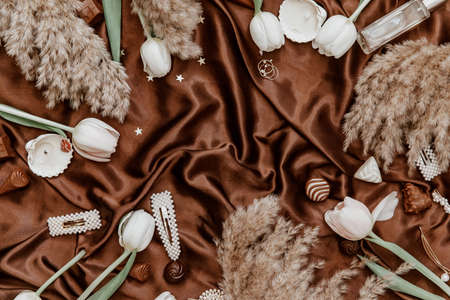 Flat lay women's fashion accessories, white tulips and candles. Creative composition for fashion blog, web, social media. Top viewの写真素材