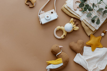 Newborn baby accessory and wooden toys in a box on a brown background. Top view, flat lay. Baby shower. Newborn stuffの写真素材