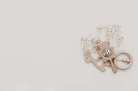 Flat lay Stylish wooden toy for kids on beige background. Gender neutral. Organic and natural toys. Eco friendly plastic free toys for toddler. Top view, card for textの写真素材