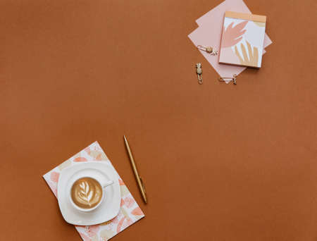 Femenine Creative flat lay photo of workspace desk with coffee cup and notebook, top view, copy...