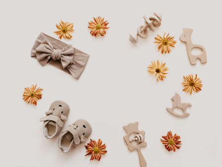 Newborn baby background. wooden toy with accessories for kids on beige background. Gender neutral. Organic and natural toys. Eco friendly plastic free toys for toddler. Ecology zero wasteの写真素材