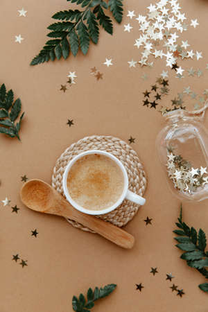 Flat lay White cup of coffee on brown background from above. Still life, lifestyle minimal concept. Top view with copy spaceの写真素材
