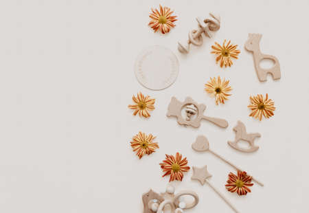Flat lay Stylish wooden toy for kids on beige background. Gender neutral. Organic and natural toys. Eco friendly plastic free toys for toddler. Top view, card for textの写真素材