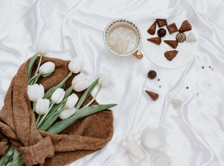 Flat lay fresh white tulips on silk background, womans Day, spring flowers conceptの写真素材