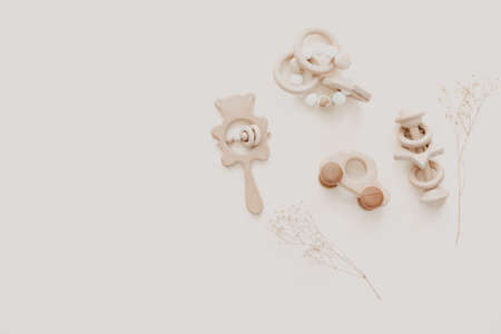 Flat lay Stylish wooden toy for kids on beige background. Gender neutral. Organic and natural toys. Eco friendly plastic free toys for toddler. Top view, card for textの写真素材