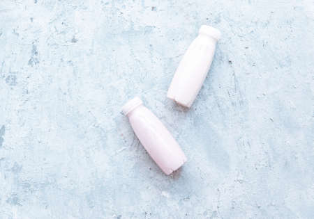 Flat lay Tasty strawberry milk shake in bottle on white background. Strawberry smoothies. Strawberry and yogurt. Top view, flat lay, copy spaceの写真素材