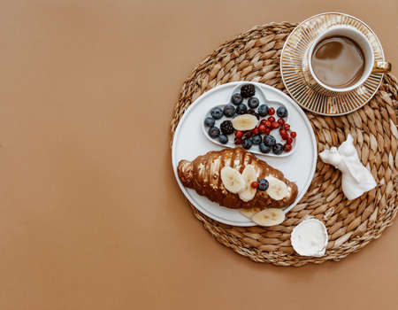 Mothers Day, 8 March, Good morning. White Fresh Tulips, Coffee cup and croissant on brown...