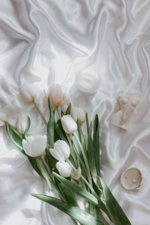 Spring, wedding still life. Silk background with tulips and accessories, Feminine background, fashion blogger, aesthetic styleの写真素材