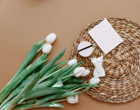 Greetings card, Spring composition. White tulips and candle on brown background. Mother day, March 8. Blank greeting card. Flat Lay, Still life compositionの写真素材