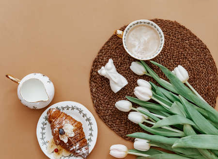 Cup of coffee with bouquet of white tulips.Valentines, Mothers, Womens Day morning concept. Top...