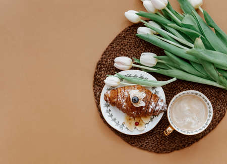 Flat Lay, coffee, croissant and white tulips. Breakfast on Mothers day, Valentines Day or Women day....