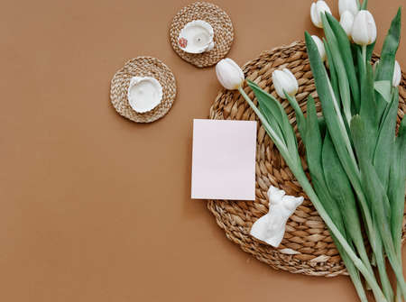 Greetings card, Spring composition. White tulips and candle on brown background. Mother day, March...