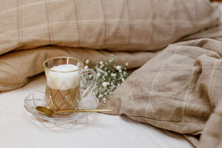 Cappuccino coffee on bed, cozy still life, morning concept, blogger style, warm styled still lifeの写真素材