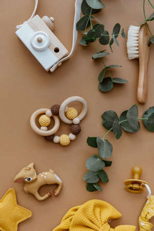 Set newborn accessories for baby on brown background. Baby shower or baby care concept. Flat lay, top viewの写真素材