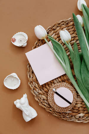 Greetings card, Spring composition. White tulips and candle on brown background. Mother day, March...