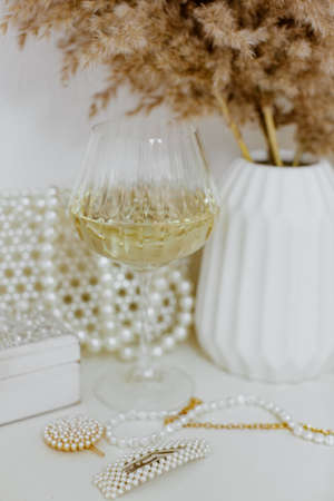 Pampas grass in white ceramic vase with glass of white wine .Still life bouquet of dried flowers. Minimal concept. Hygge, Lagom, Vintageの写真素材