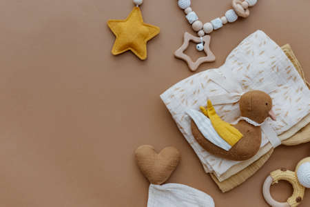 Knited toys for kids, baby staff, newborn accessory on brown background. Baby shower. Flat lay, top viewの写真素材