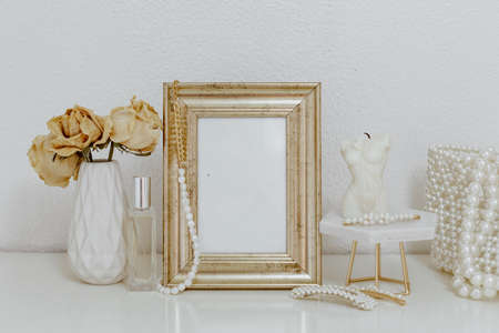 Feminine Mockup vintage gold frame and candle. Wedding still life. Cozy Aesthetic Background. Parisian chicの写真素材
