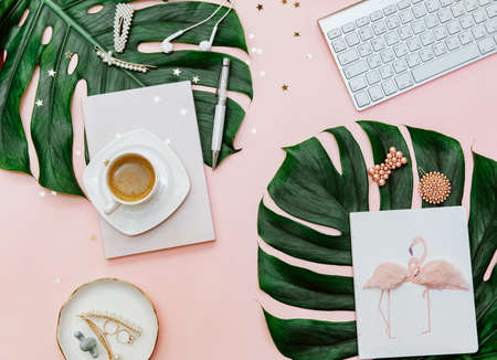Feminine flat lay, mock up clipboard on tropical pink background for bloggers, modern home office desk with pastel pink, coffee cup, and stationery.の写真素材