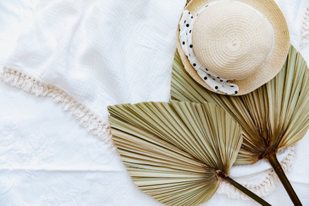 Flat lay with straw hat and palm leaf. Top view, summer conceptの写真素材