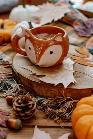 Coffee cup on stylish cozy background with pumpkins, autumn leaves. Hello autumn, still life, fall, Happy Thanksgiving. Autumn compositionの写真素材