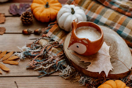 Coffee cup on stylish cozy background with pumpkins, autumn leaves. Hello autumn, still life, fall, Happy Thanksgiving. Autumn compositionの写真素材