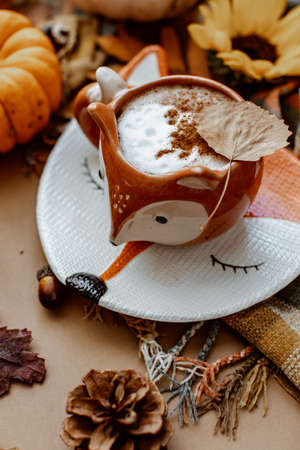 Autumn or Fall composition. Fall leaves, hot steaming cup of coffee on brown background. Mood, lifestyle, still life concept. Flat layの写真素材