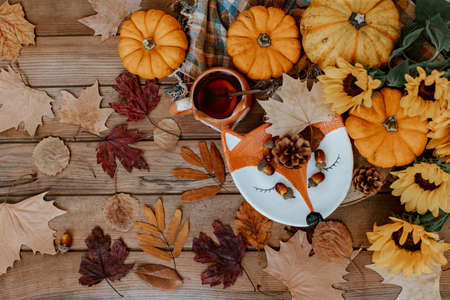 Autumn composition with dried leaves, pumpkins on wooden background. Autumn, fall, halloween, thanksgiving day concept. Flat lay, top view, copy space. Autumn still lifeの写真素材