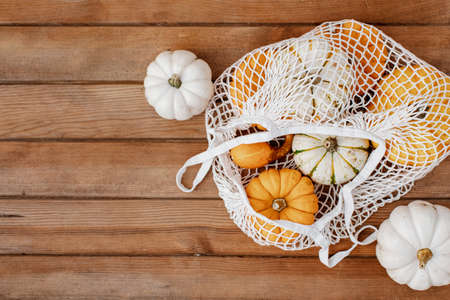 Flat lay varied Pumpkins on wooden background. Autumn cozy concept, orange pumpkins, Happy Thanksgiving. Autumn composition with pumpkinsの写真素材