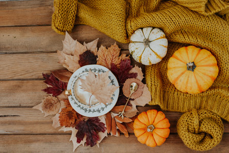 Coffee composition with autumn leaves, warm sweater and on wooden background, Autumn still lifeの写真素材