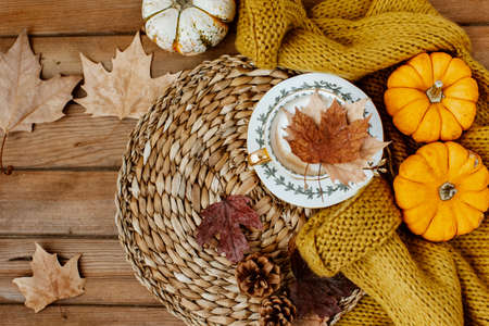Flat lay Autumn still life with a coffee cup and pumpkins on wooden background. Stylish autumn composition.の写真素材