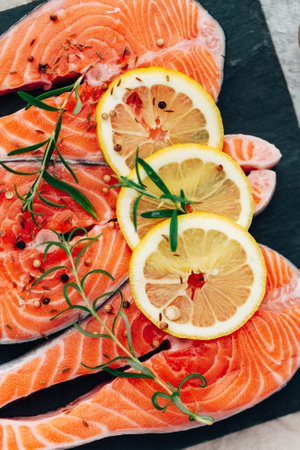 Fresh raw Salmon. fish fillet with herbs and lemon. healthy food, diet or cooking conceptの写真素材