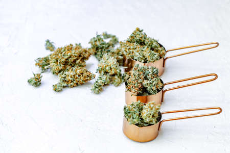 Marijuana buds, leaves and resin, flat lat, top view. Cannabis flowers on gray background. Hemp recreation, home pastime, legalization concept.の写真素材