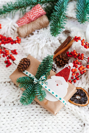 Christmas background with gift box and Christmas decorations on cozy knitted background. Flat lay, top view and copy space for textの写真素材