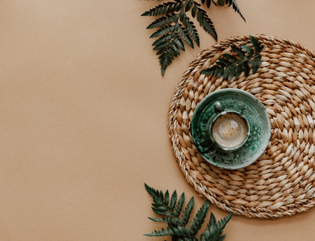 Cup of coffee with milk on brown background. Top view, bright light.の写真素材