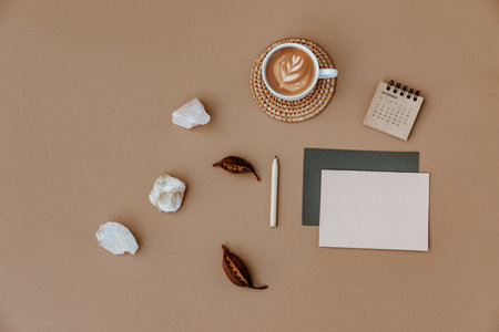 Minimal aesthetic business brand, blog, social media template. Blank card, coffee cup and dry leaves on neutral background. Flat lay, top viewの写真素材