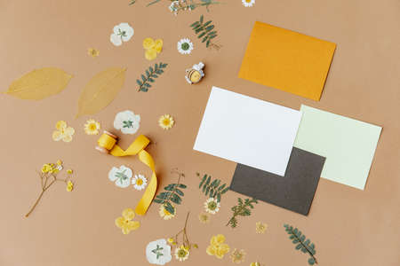 Spring or wedding or birthday mock up scene. Blank open sheet of paper and flowers with place for text for greeting card copy space. Flat lay, top viewの写真素材