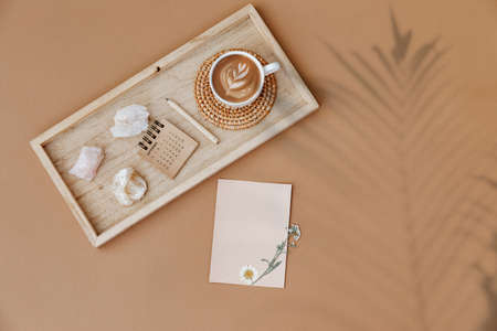 Flat lay Minimal aesthetic background with blank card and calendar on beige background. Wedding planning, invitation template. Flat lay, top view, mock up, copy spaceの写真素材