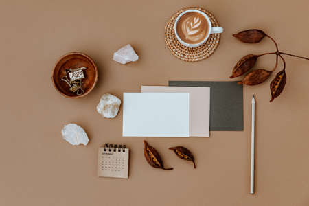 Minimal aesthetic background with blank card, coffee and calendar on beige background. Wedding...