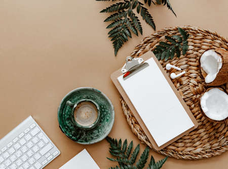 Desktop mockup planner. Flat lay with clipboard, coffee cup and green leaves on brown background.Zero waste, eco friendly, natural organic concept.の写真素材